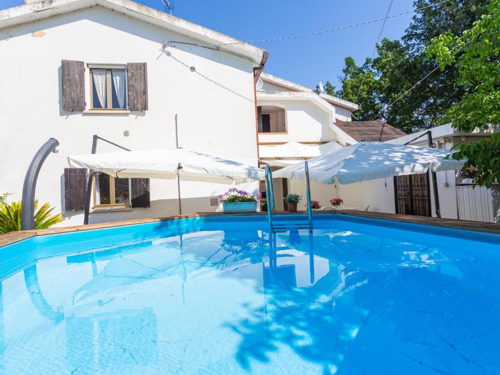 a swimming pool in front of a house at Holiday Home Le Querce - PIT550 by Interhome in Atri