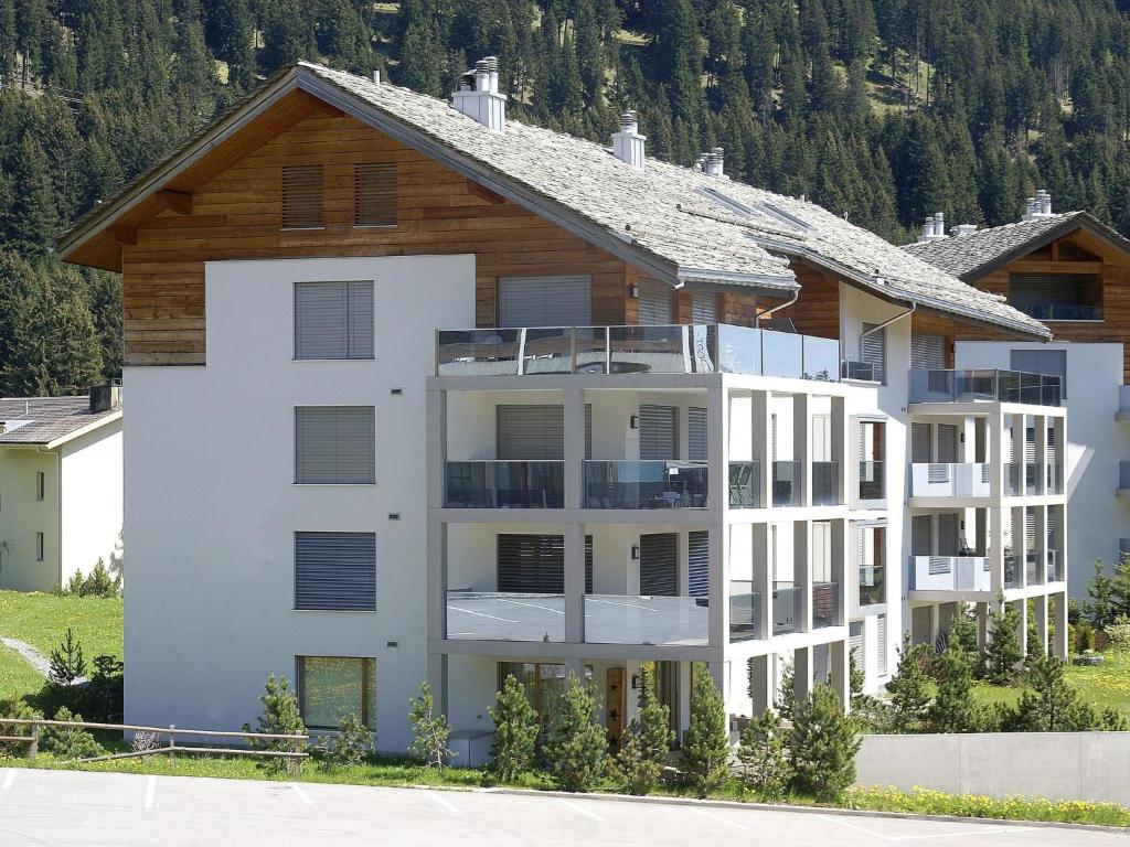 a large apartment building in front of a mountain at Apartment Kulm 1 by Interhome in Valbella