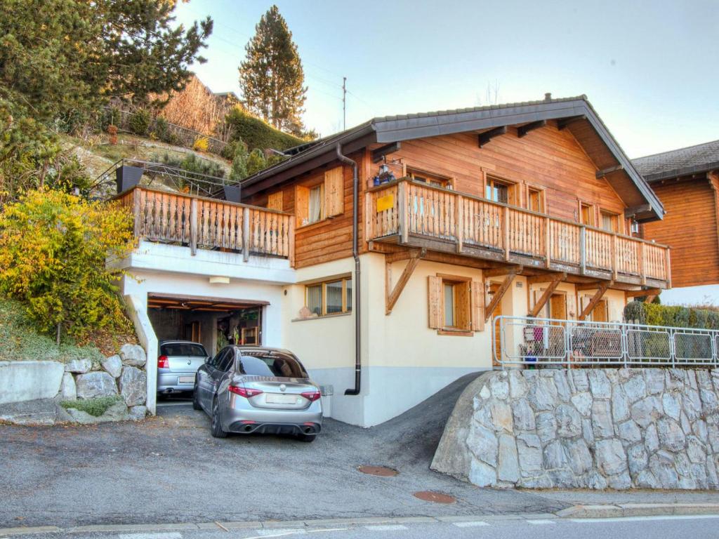 a house with a car parked in front of it at Chalet Le Dahu by Interhome in Veysonnaz