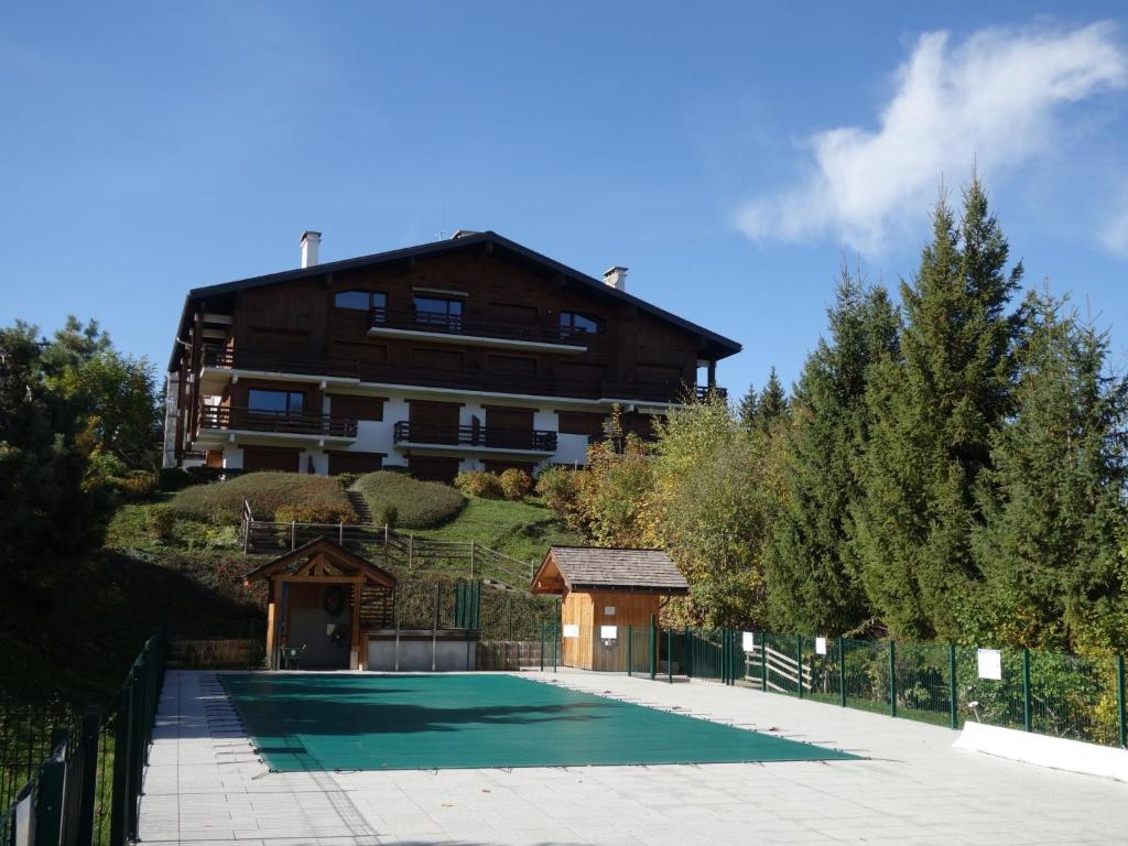 a house with a tennis court in front of a house at Apartment La Christaz-6 by Interhome in Saint-Gervais-les-Bains