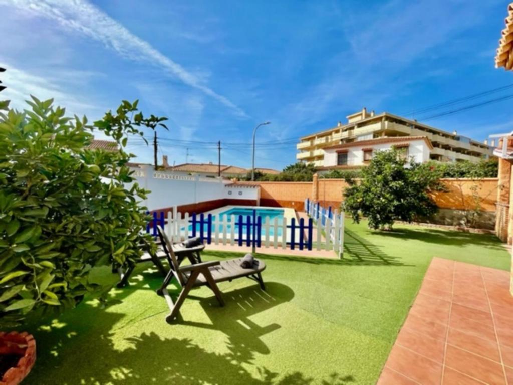 a garden with a bench and a fence at Holiday Home Villa Anita by Interhome in Rincón de la Victoria