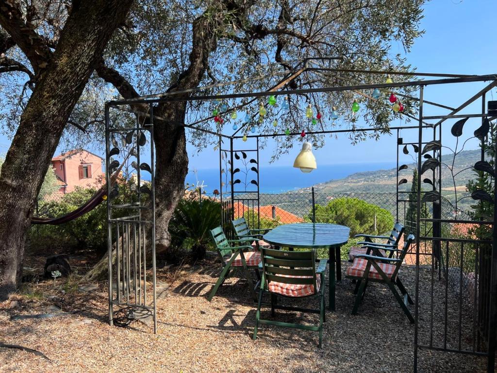 a patio with a table and chairs under a tree at Holiday Home Villa Valentina by Interhome in Serreta