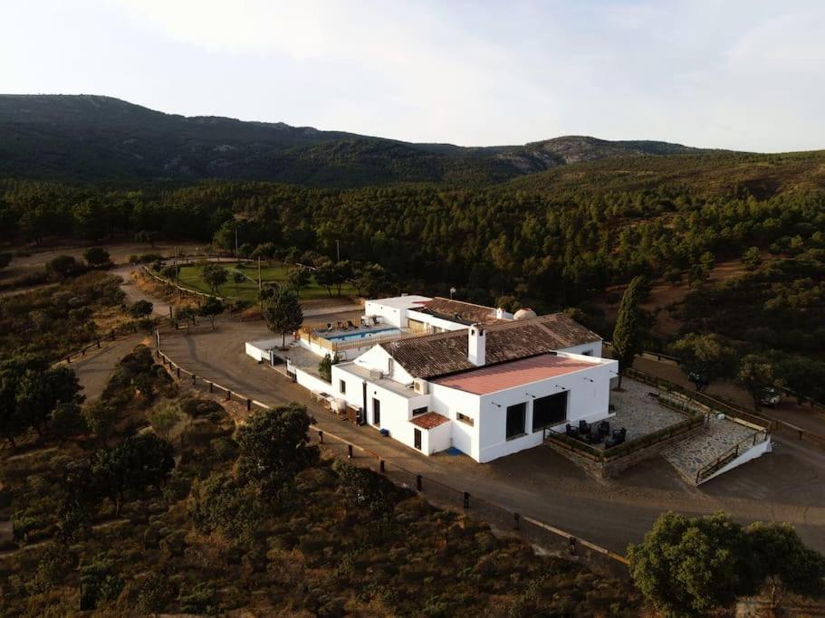 an aerial view of a white house in the hills at Finca El Jaral in Santa Elena