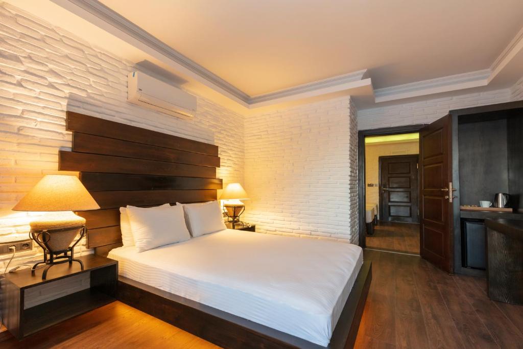 Postel nebo postele na pokoji v ubytování Manaspark Deluxe Hotel