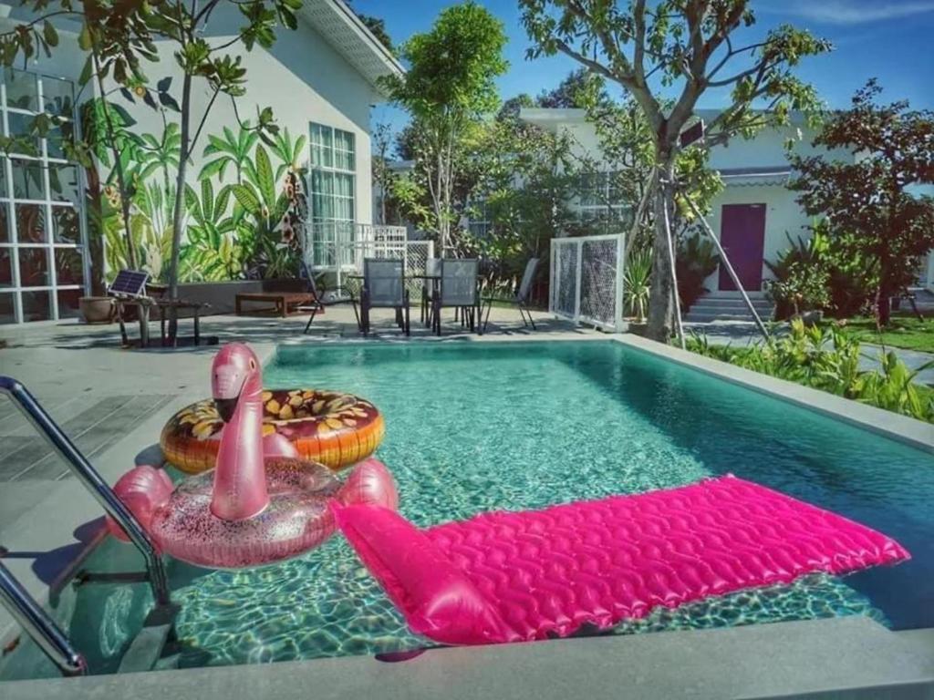 a swimming pool with a rubber duck and a float at Utapao sattahip rayong resort in Ban Nong Sa