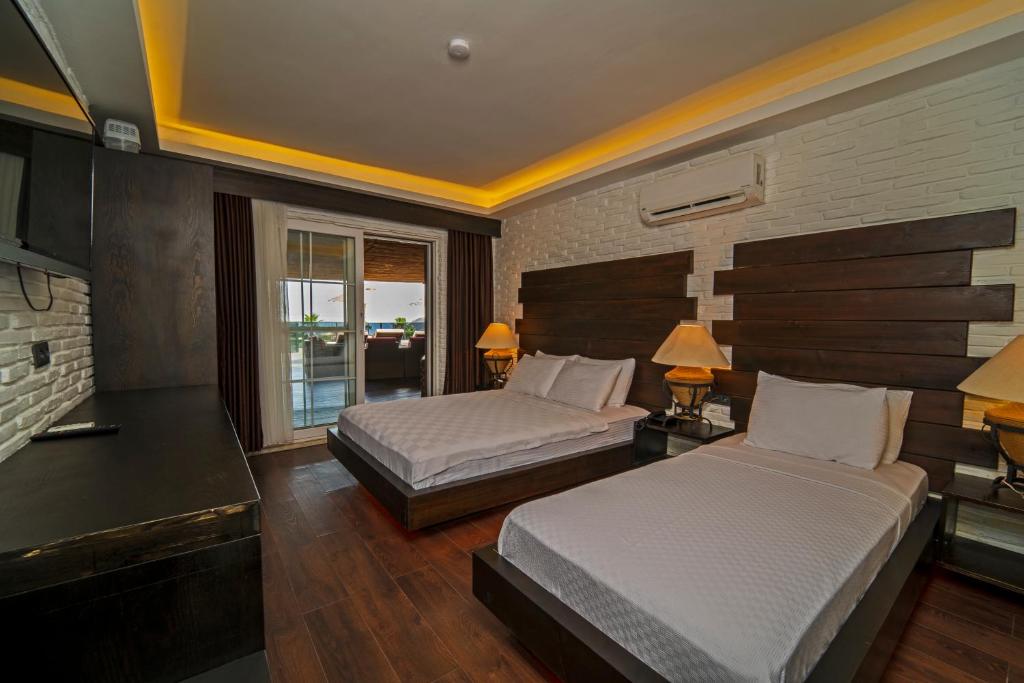 Postel nebo postele na pokoji v ubytování Manaspark Deluxe Hotel