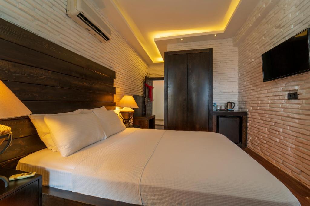 Postel nebo postele na pokoji v ubytování Manaspark Deluxe Hotel