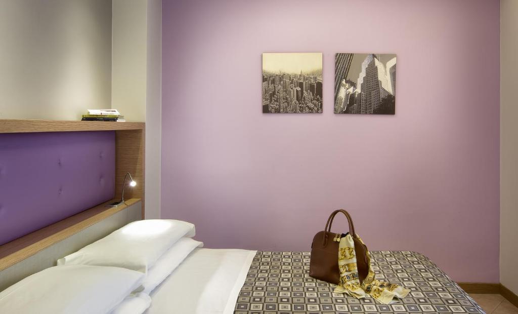 Postel nebo postele na pokoji v ubytování ACasaMia WelcHome Hotel