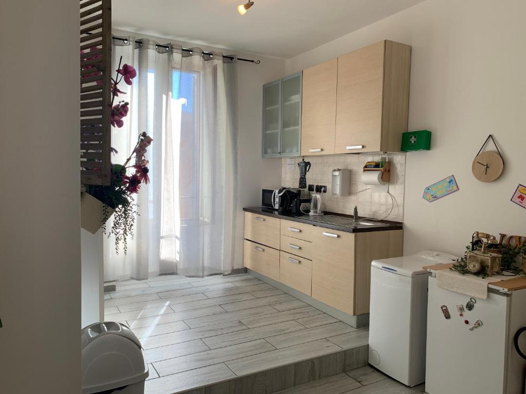 a kitchen with wooden cabinets and a white refrigerator at Julius Caesar 183 in Rome