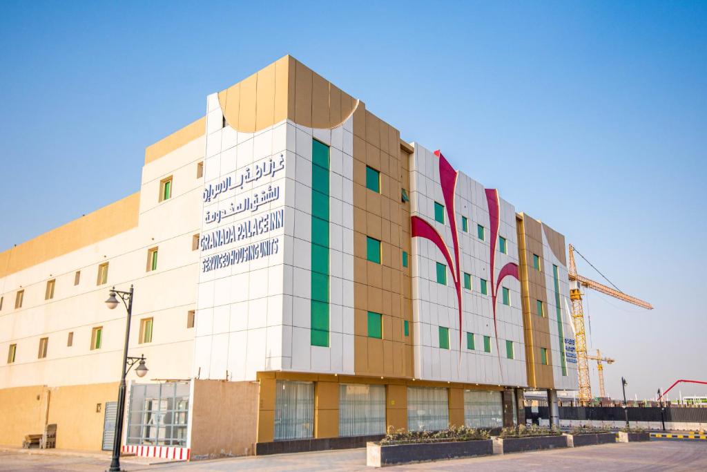 a building in a city with a crane at Granada Palace Inn in Riyadh