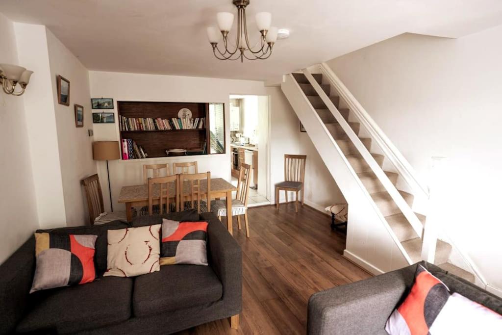a living room with a couch and a dining room at Welsh holiday home sleeps 5 close to beaches & mountains in Nantlle