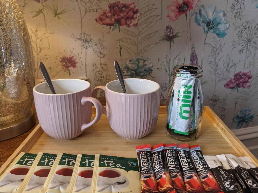 a table with two cups and a can of soda at Blue Keys Hotel Southampton in Southampton