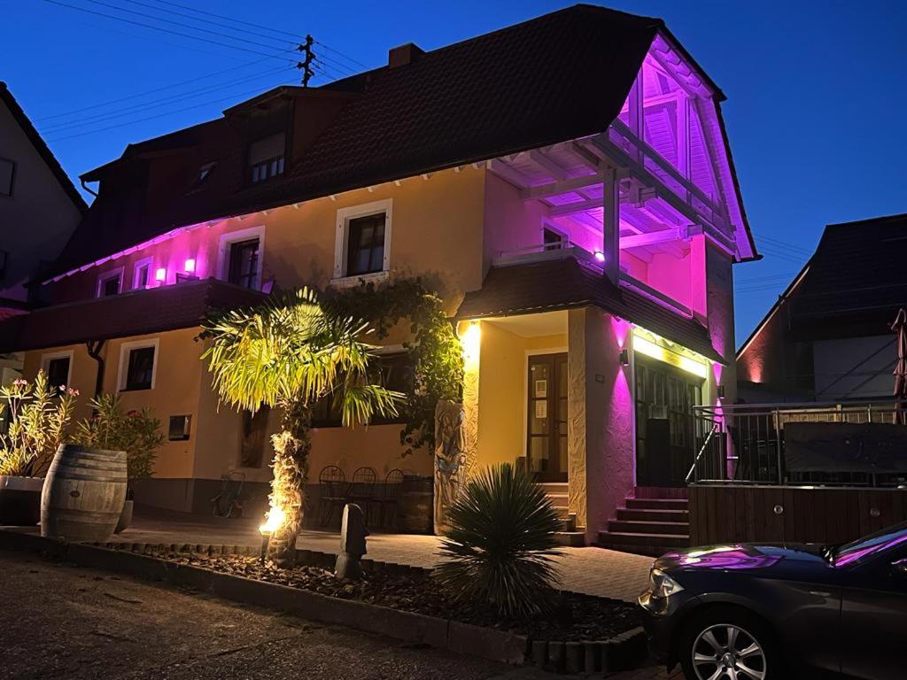una casa con luci viola sulla parte anteriore di Rebstöckel a Schweigen-Rechtenbach