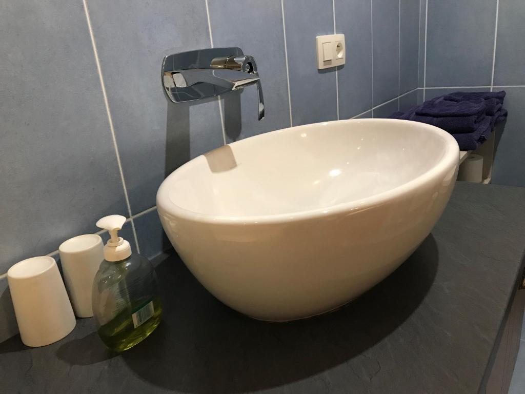 a white bowl sink sitting on a counter in a bathroom at Maison Chabrat in Liginiac