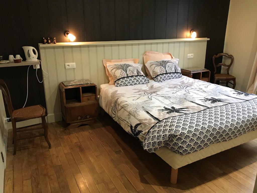 a bedroom with a large bed with two pillows at Maison Chabrat in Liginiac