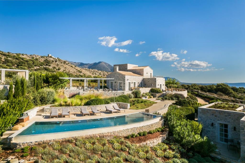 an aerial view of the house and its swimming pool at Ariá Estate Suites & Spa in Areopolis