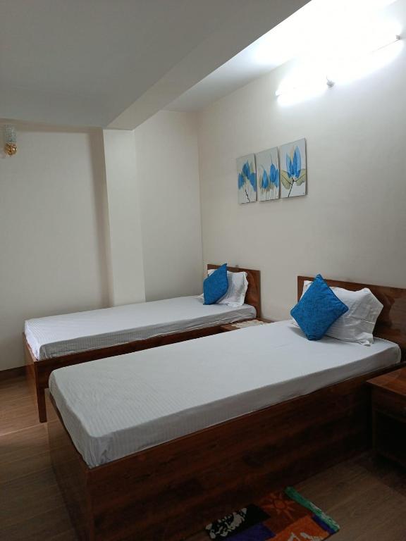 Postel nebo postele na pokoji v ubytování Maple Homestay
