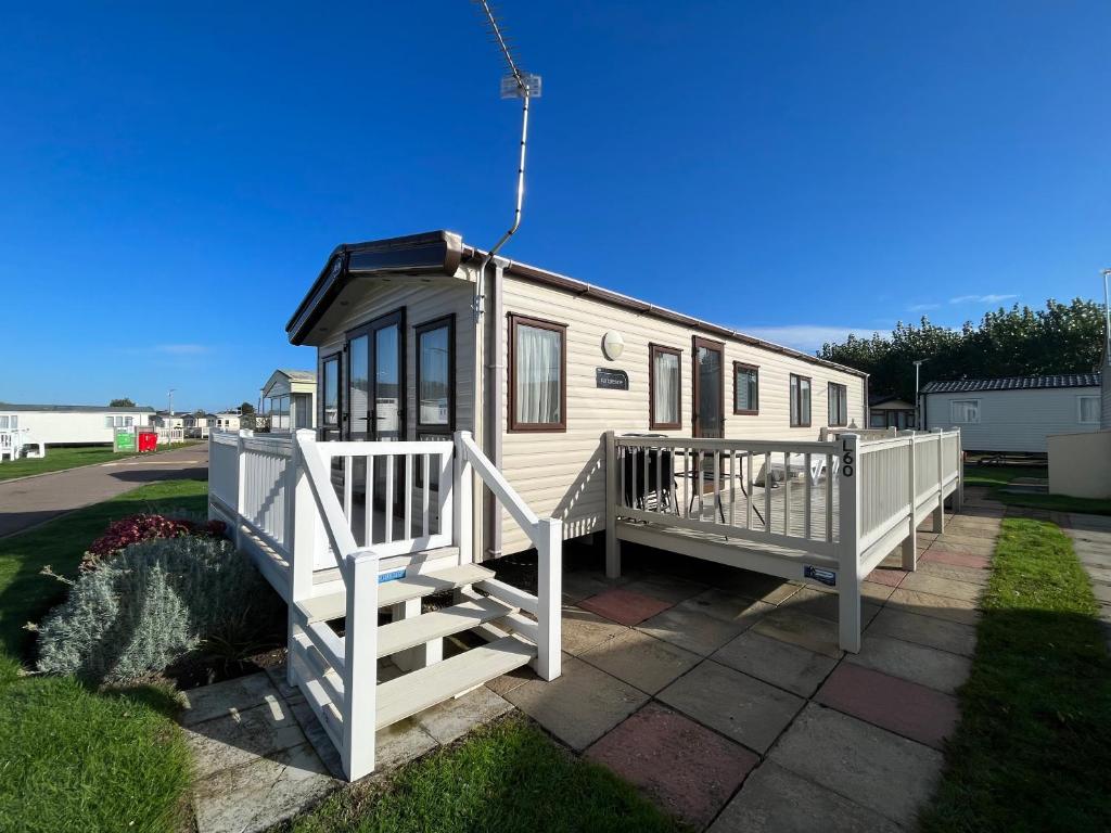 a tiny house with a porch and a staircase at Lapwing 60, Scratby - California Cliffs, Parkdean, sleeps 6, bed linen and towels included, no pets in Great Yarmouth