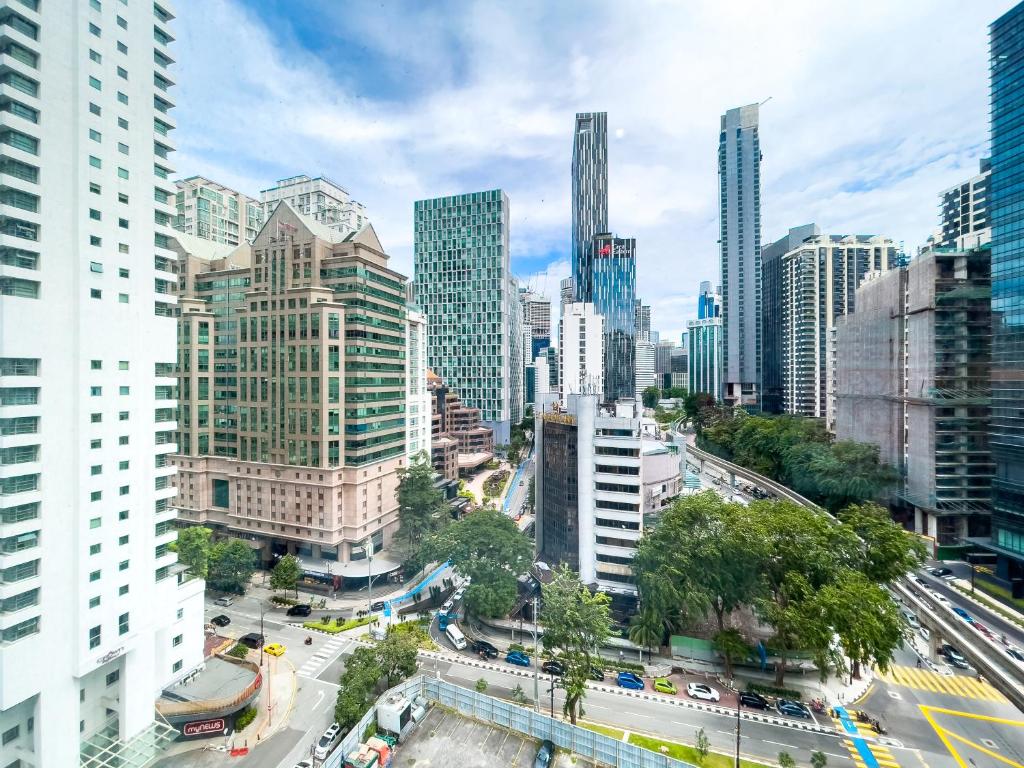 a city with a busy street in front of tall buildings at Vortex suites klcc by Surat in Kuala Lumpur