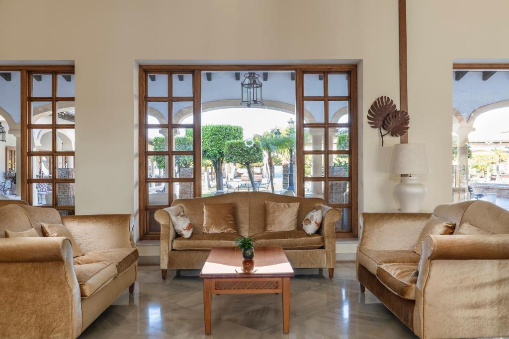 a living room with two couches and a table at Iberostar Selection Andalucia Playa in Chiclana de la Frontera