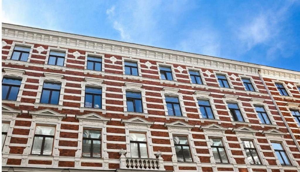 a large brick building with many windows on it at Riga Center - Quiet Studio - 5 min to Old Town & NFLX in Rīga