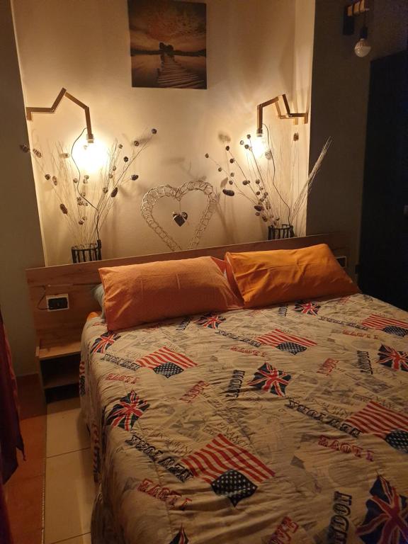 a bedroom with a bed and two lights on the wall at ROMEO2 in Somma Lombardo