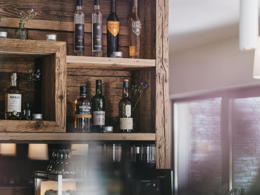 a shelf with bottles of alcohol on it at VAYA Sölden inklusive Summer Card in Sölden