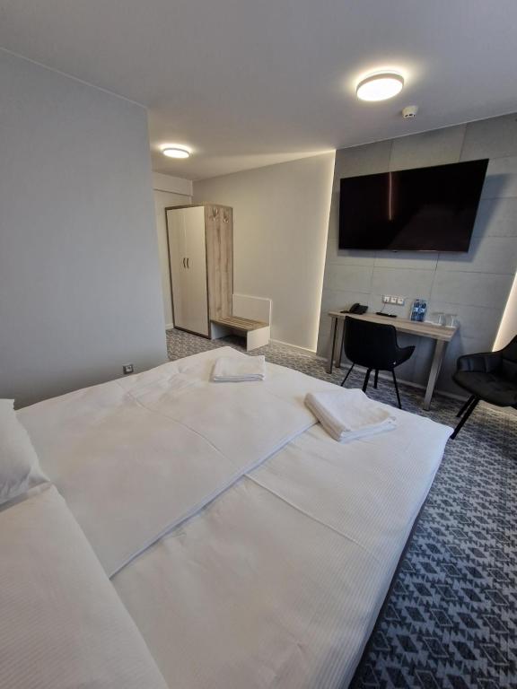 Łóżko lub łóżka w pokoju w obiekcie Hotel Gordon