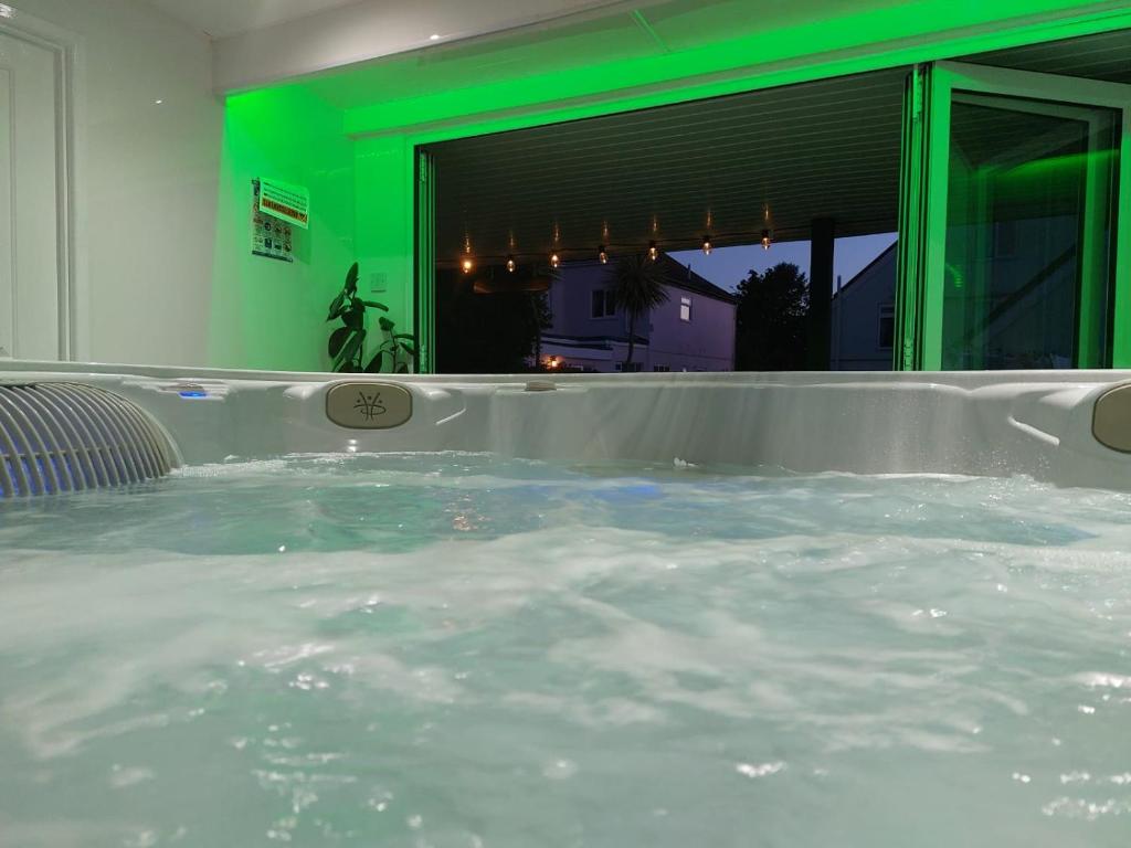 a jacuzzi tub in a house with water at Earlston House in Paignton