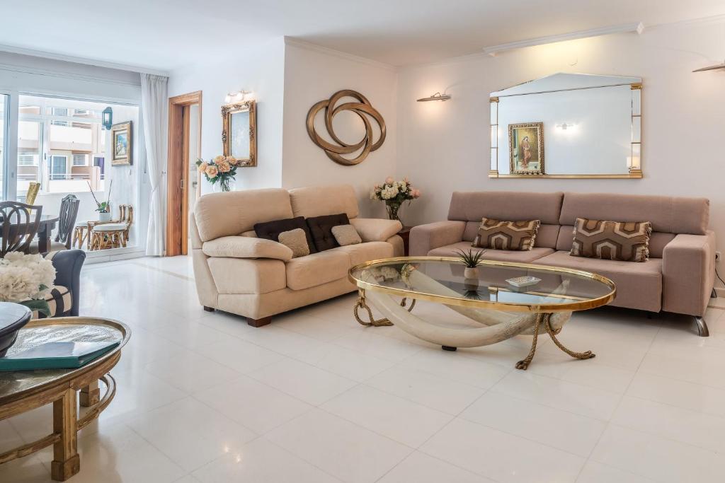 a living room with a couch and a table at Deluxe Apartment on the First Line in Marbella