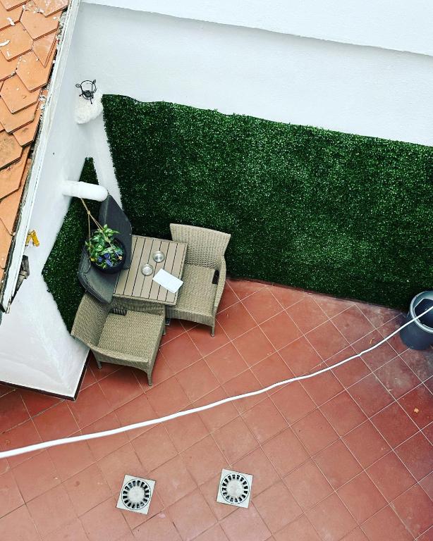 an outdoor patio with two chairs and a table at Brasov Place in Braşov