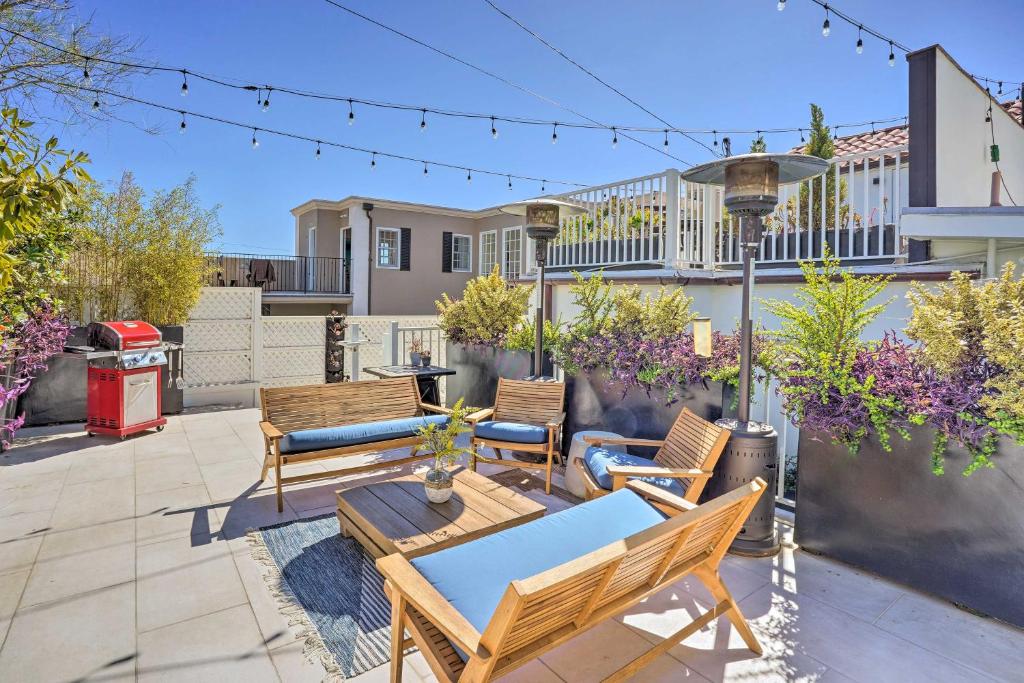 a patio with chairs and a table on a patio at Luxe Laguna Home with Ocean View Walk to Beach in Laguna Beach