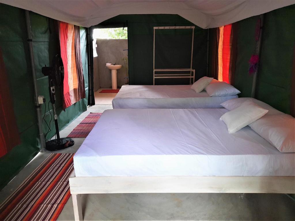 Postel nebo postele na pokoji v ubytování Nirvaan Safari Lodge