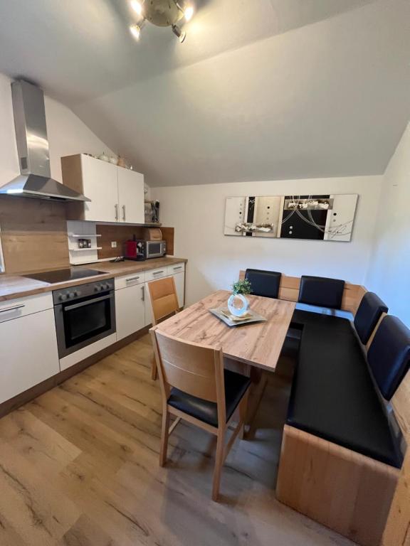 a kitchen and dining room with a table and chairs at Haus Knauß in Schladming