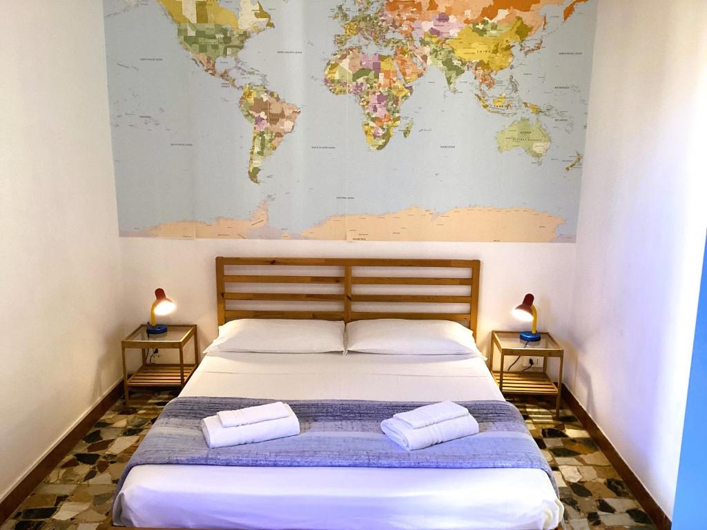 a bedroom with a bed with a map on the wall at Colle Dei Fiori Rooms in Cagliari
