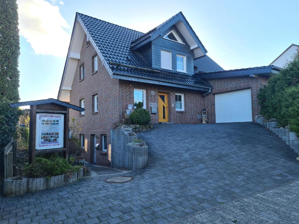 a brick house with a driveway in front of it at Haus Blume in Medebach