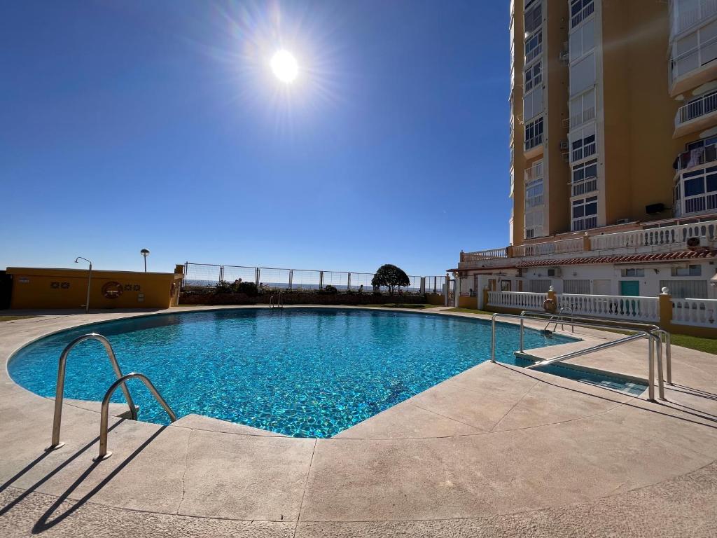 a large swimming pool in the middle of a building at Studio on the Beach Front in Sitio de Calahonda