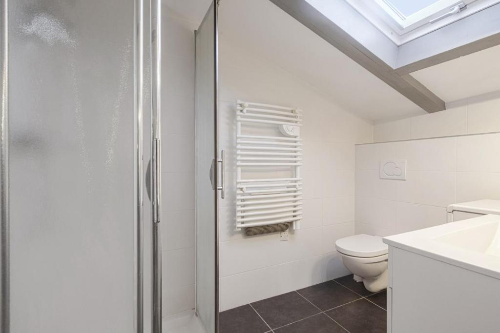 a bathroom with a shower and a toilet at Large studio with balcony at the heart of Biarritz - Welkeys in Biarritz