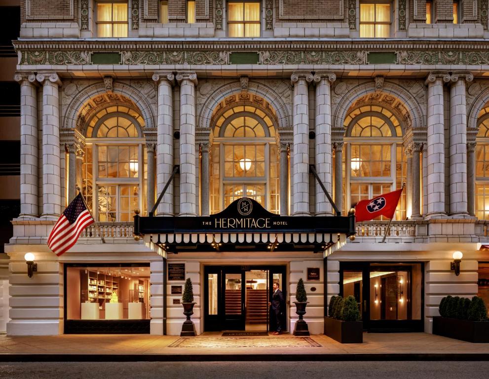 a building with a woman standing outside of it at The Hermitage Hotel in Nashville