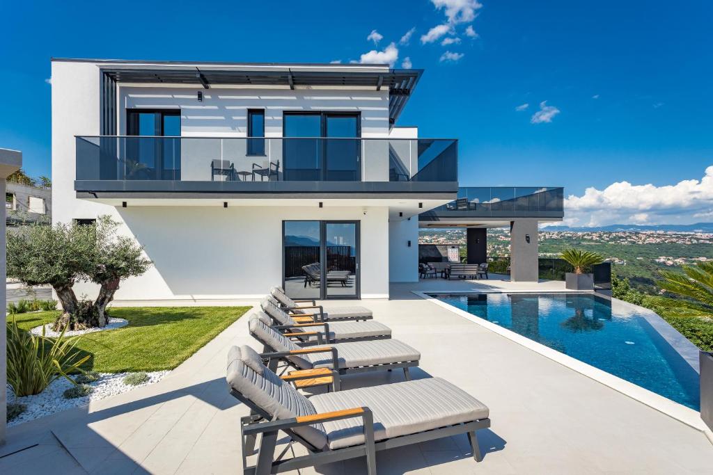 a villa with a swimming pool and a house at Villa Platinium in Opatija