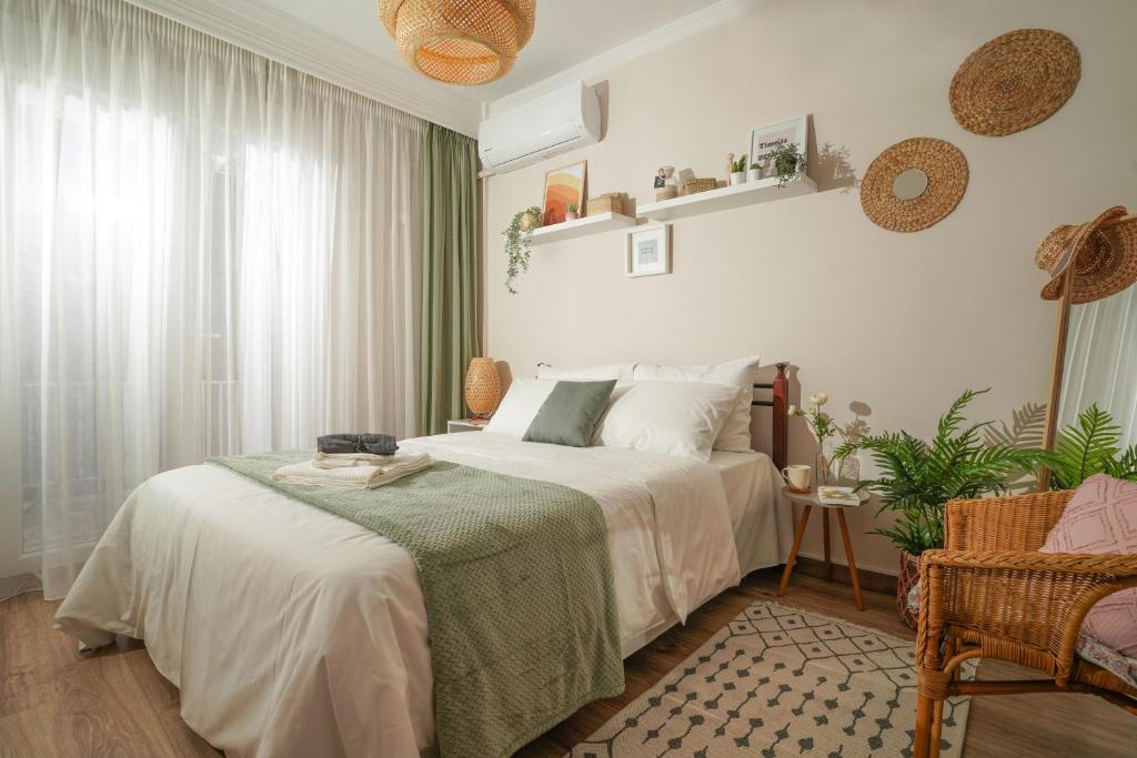 a bedroom with a bed with a green blanket at Homey Edessa in Edessa