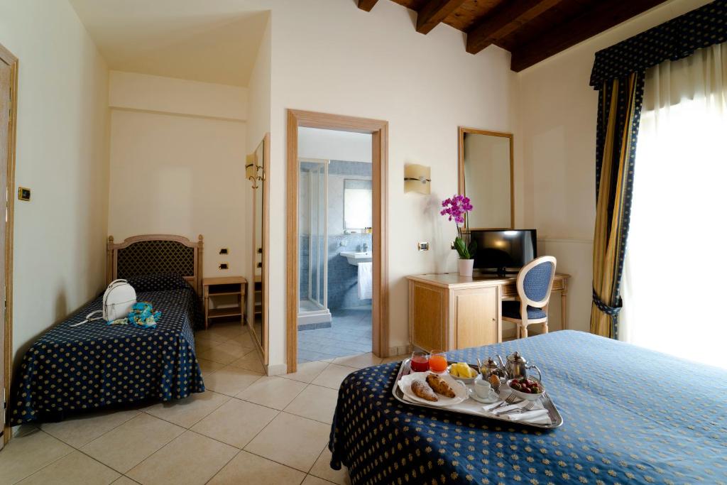 Een bed of bedden in een kamer bij Hotel Villa Romana