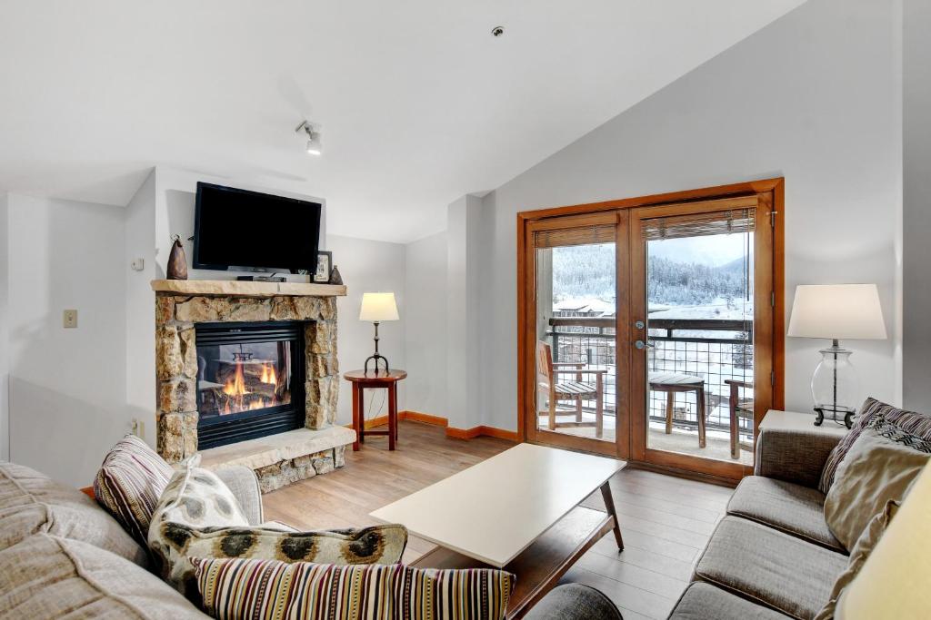 a living room with a couch and a fireplace at Ski In Out Luxury Penthouse #1706 With Hot Tub & Great Views - 500 Dollars Of FREE Activities And Equipment Rentals Daily in Winter Park