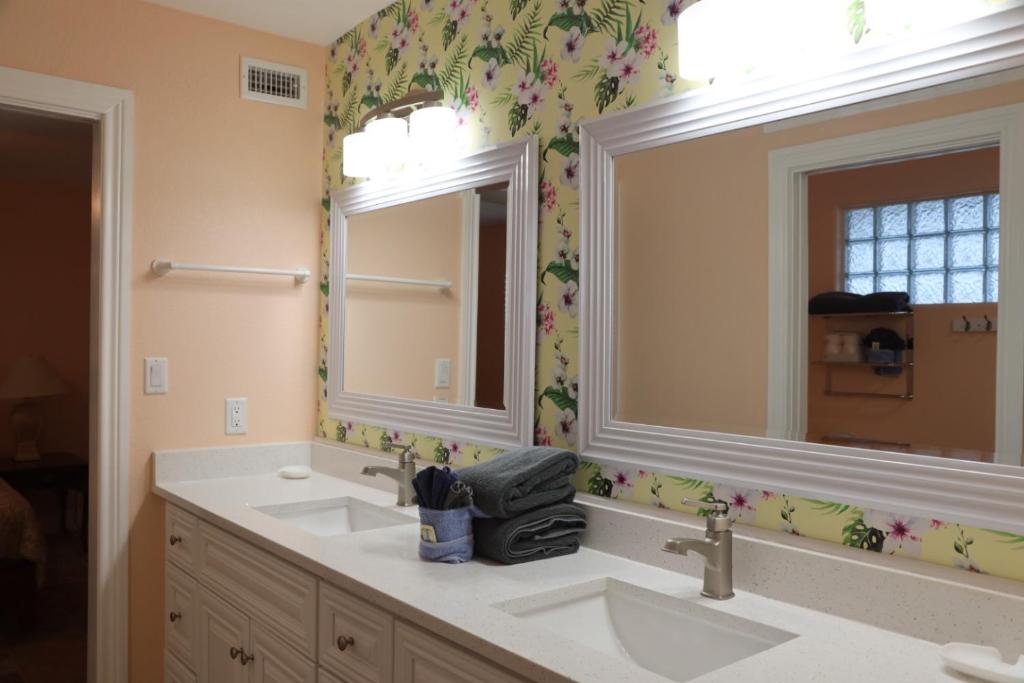 a bathroom with two sinks and a mirror at Executive Keys Condominiums on the Beach in Port Aransas