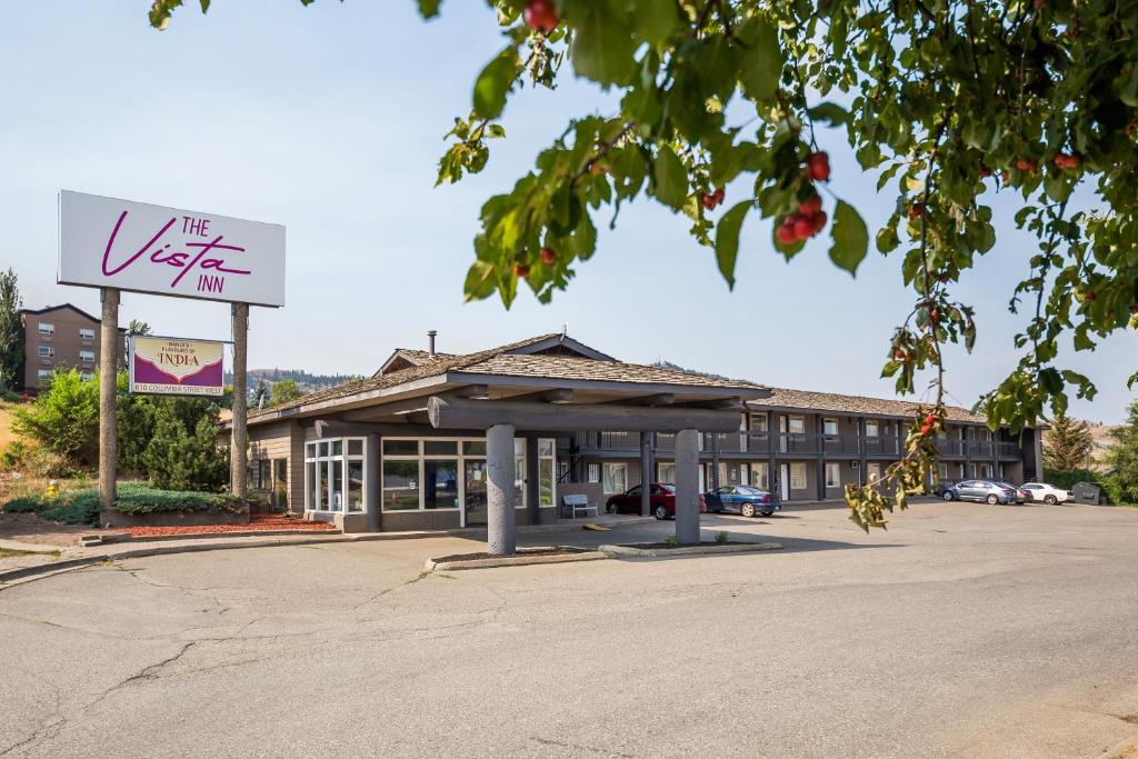 a building with a sign in a parking lot at The Vista Inn in Kamloops