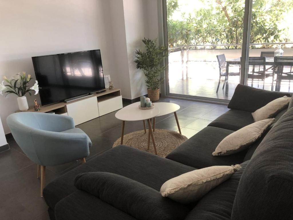 a living room with a couch and a tv at Standing Apartment Barcelona Forum in Barcelona