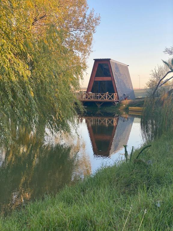 a bridge over a river with a reflection in the water at Secret Lake Tayakadın in Arnavutköy