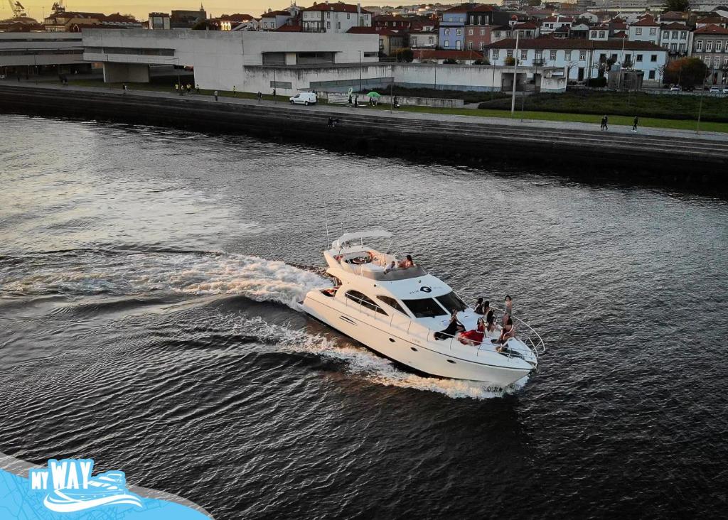 a boat in the water with people on it at Barco no Coração da Cidade - Iate de 5 estrelas in Viana do Castelo