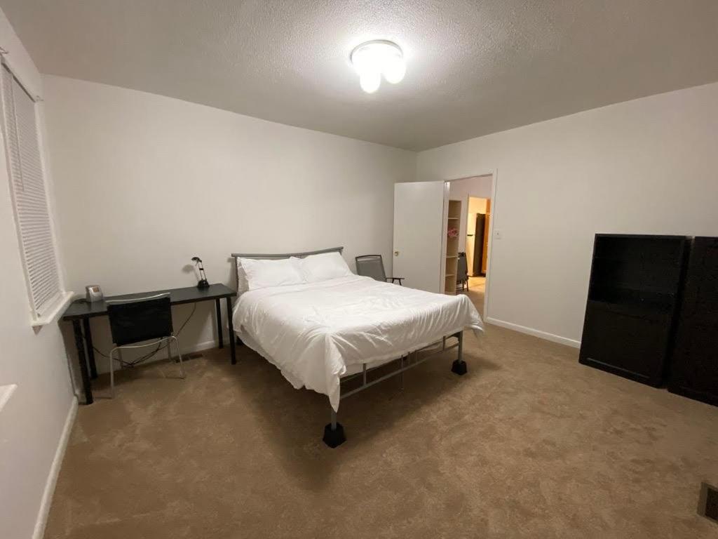 a bedroom with a bed and a desk in it at A cozy house on a waterfront property in Baltimore