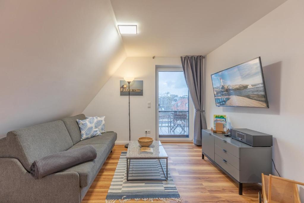 a living room with a couch and a table at Getidenhus Moand in Sankt Peter-Ording